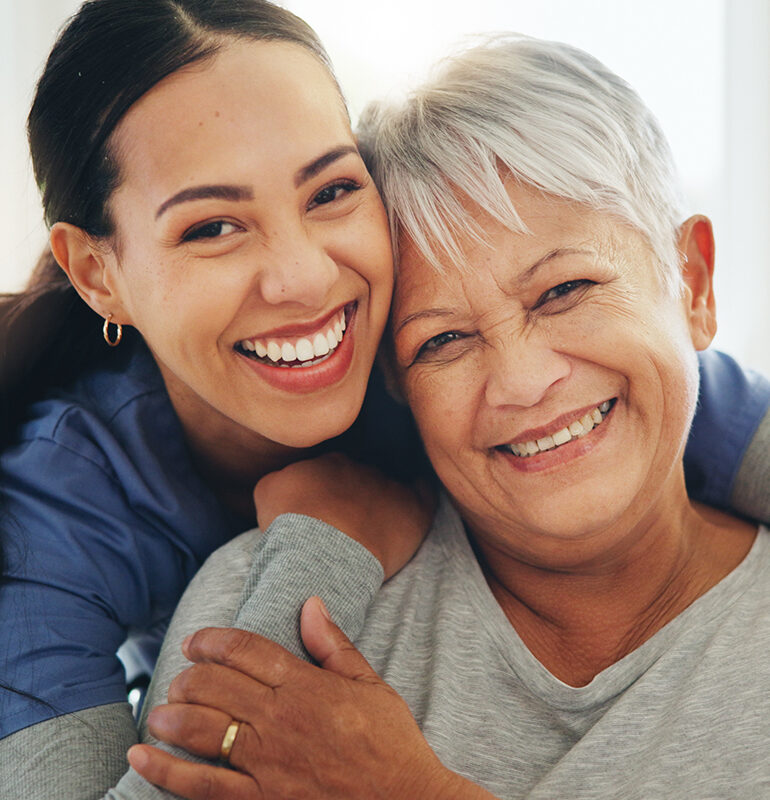 Happy woman, nurse and hug senior patient in elderly care, support or trust at old age home. Portrait of mature female person, doctor or medical caregiver hugging with smile for embrace at house